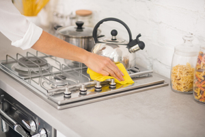 Household cleaning of stove surface with cleaning cloth