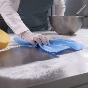 Stainless steel food prep surface cleaned with professional wipes